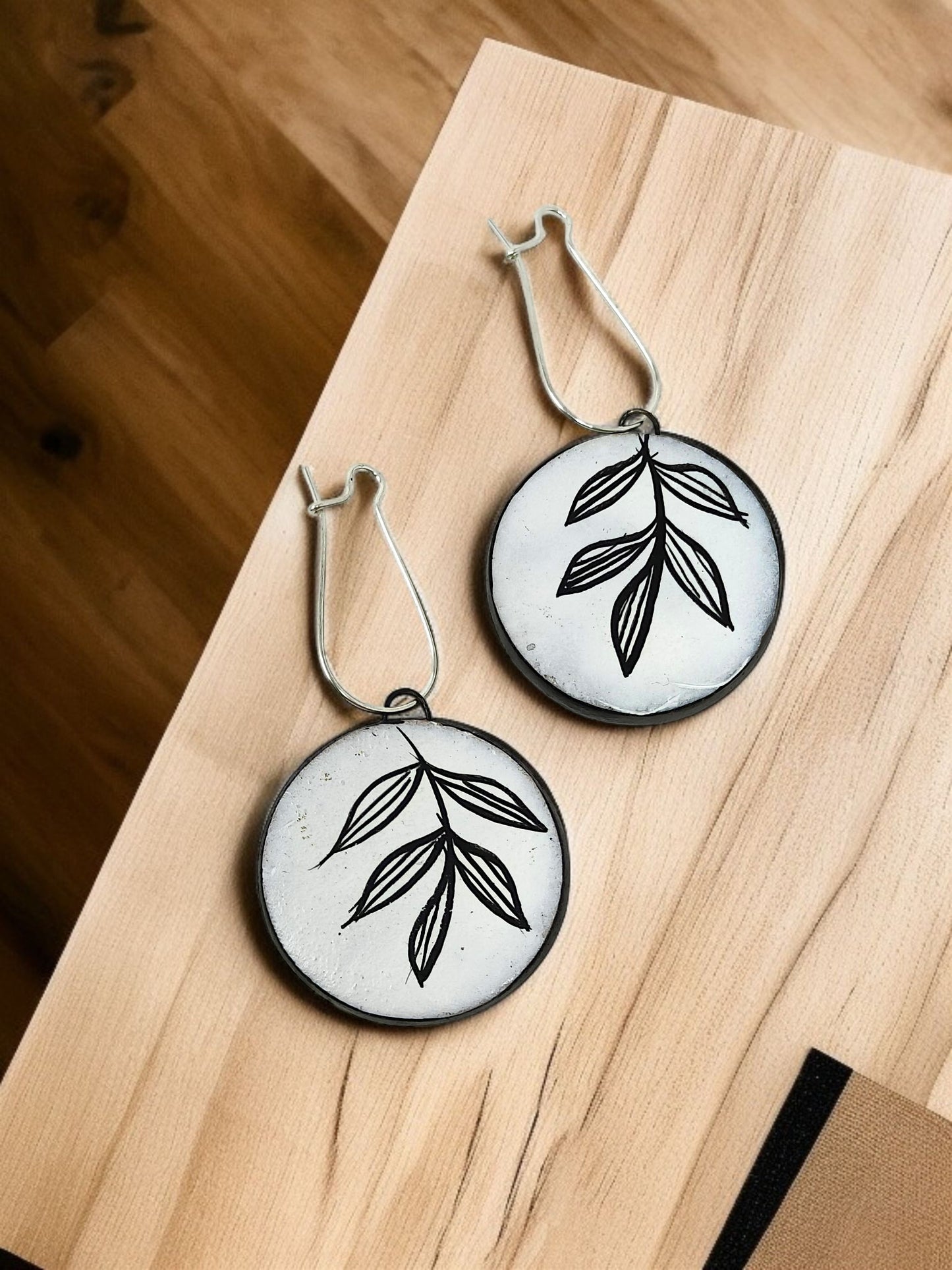Artisan Floral Pendant Necklace featuring circular silver pendants with black leaf designs by Mrritika By Astria Jewellery