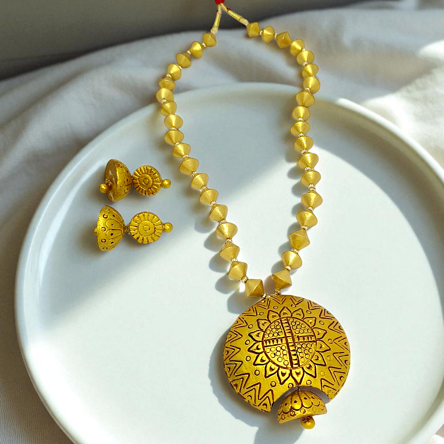 Mrritika Bishnupur Handpainted Terracotta Necklace Set with yellow beads and matching earrings on white plate
