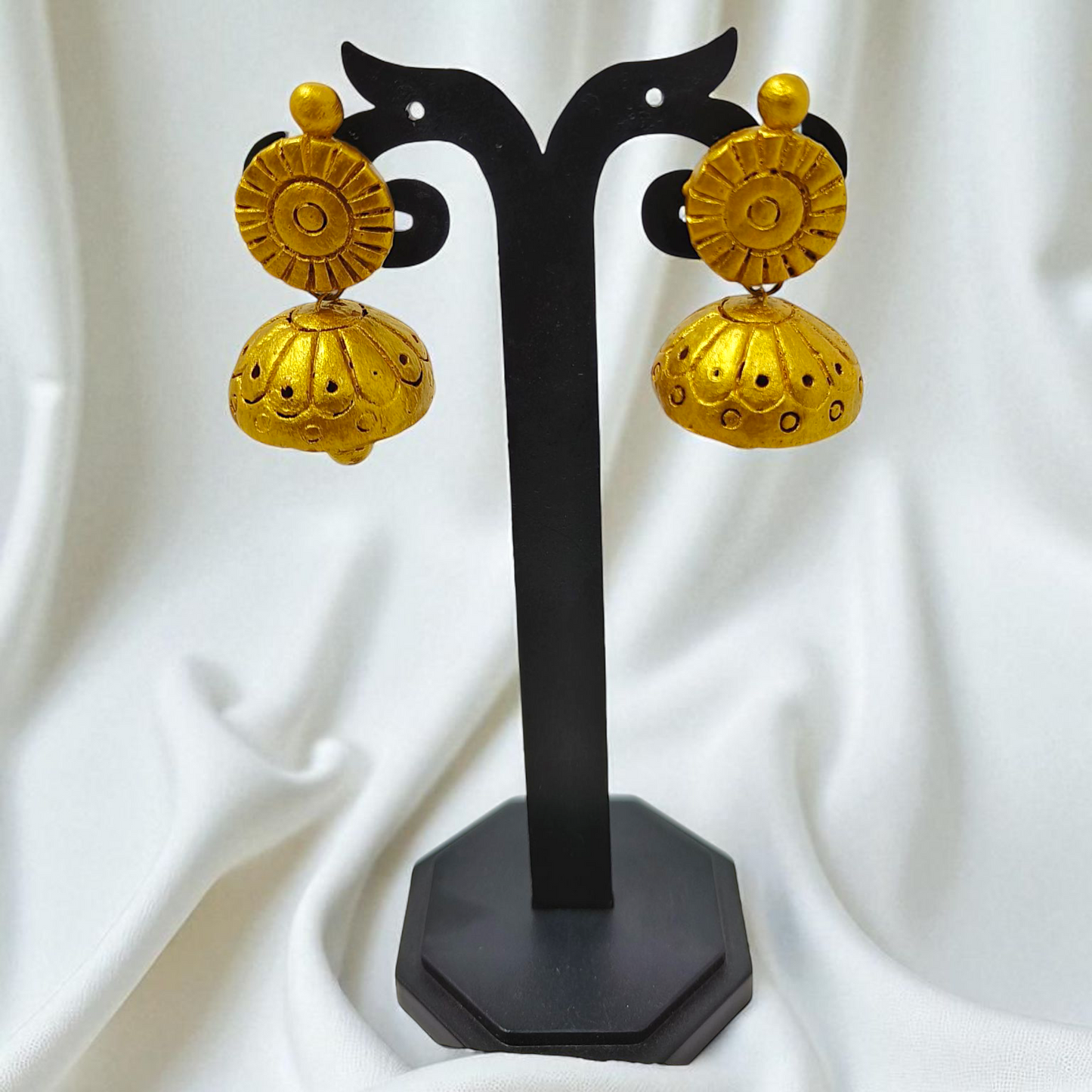 Golden yellow terracotta earrings displayed on black stand from Bishnupur Handpainted Terracotta Necklace Set by ASTRIA JEWELLERY