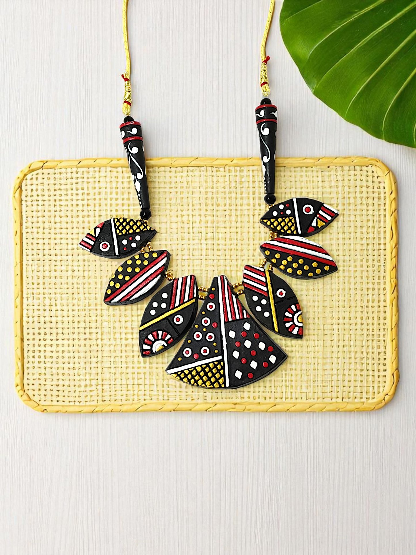 Black Trible jewelry Necklace Set featuring bold geometric patterns in red, white, and yellow on black beads