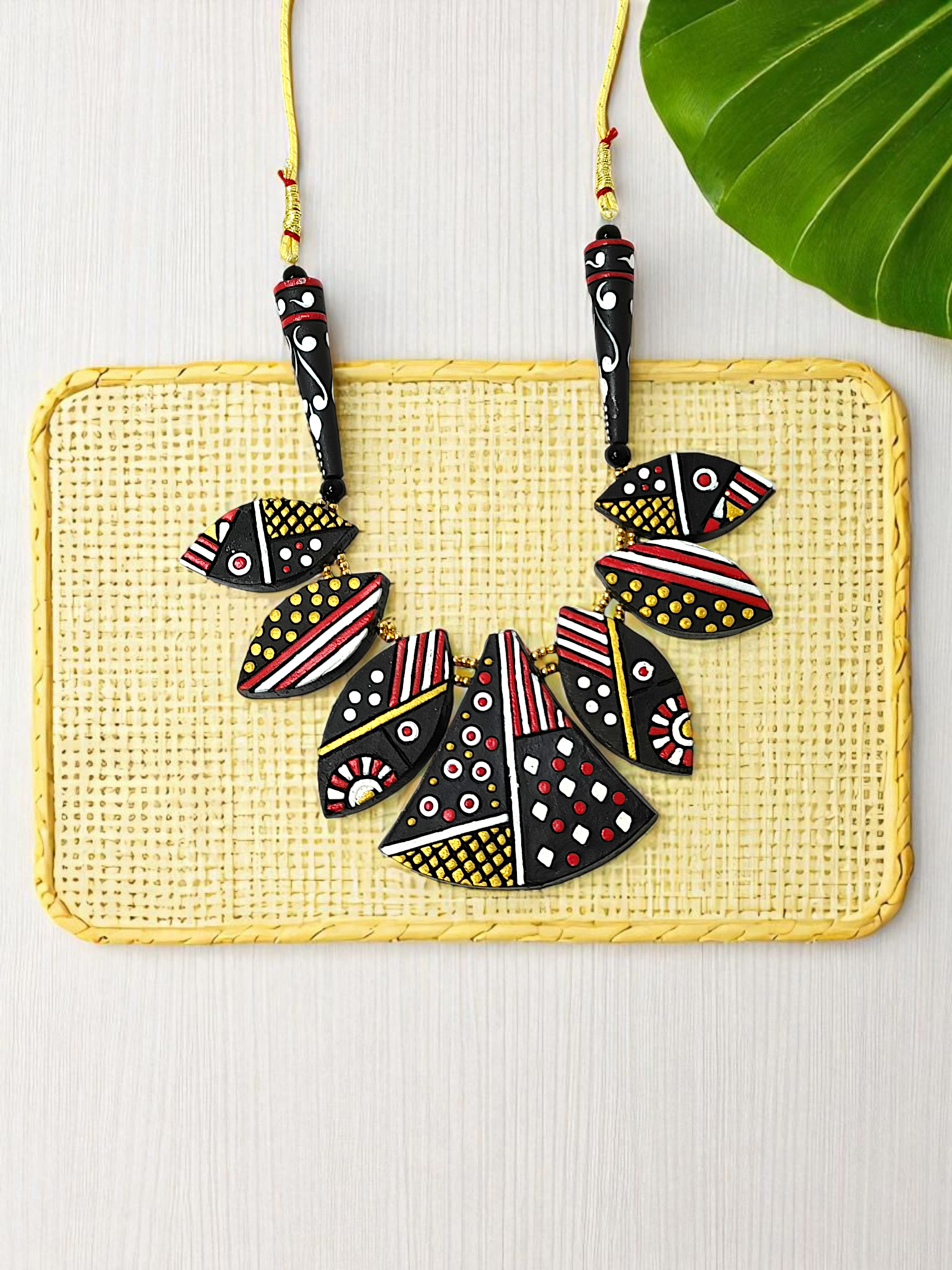Black Trible jewelry Necklace Set featuring bold geometric patterns in red, white, and yellow on black beads