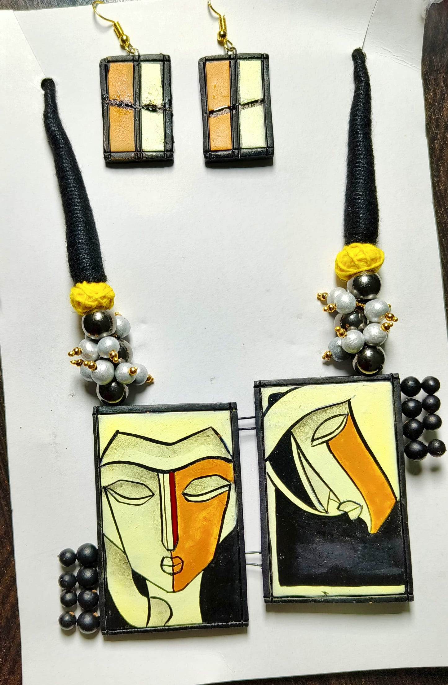 Hand crafted dual pendant necklace with abstract face art and matching rectangular earrings from ASTRIA JEWELLERY