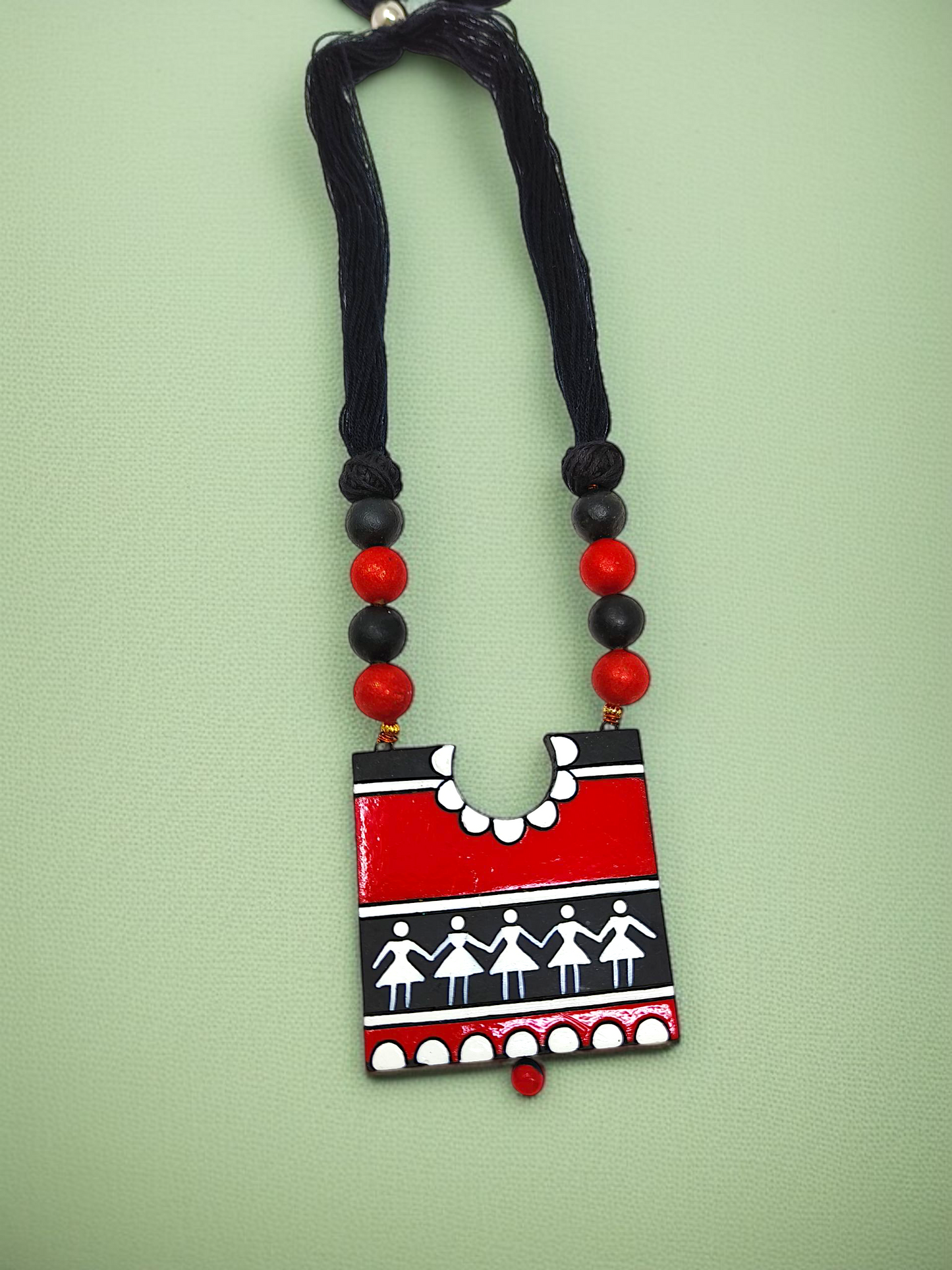 Handcrafted Warli Art Pendent and Earring featuring red and black tribal design with traditional patterns