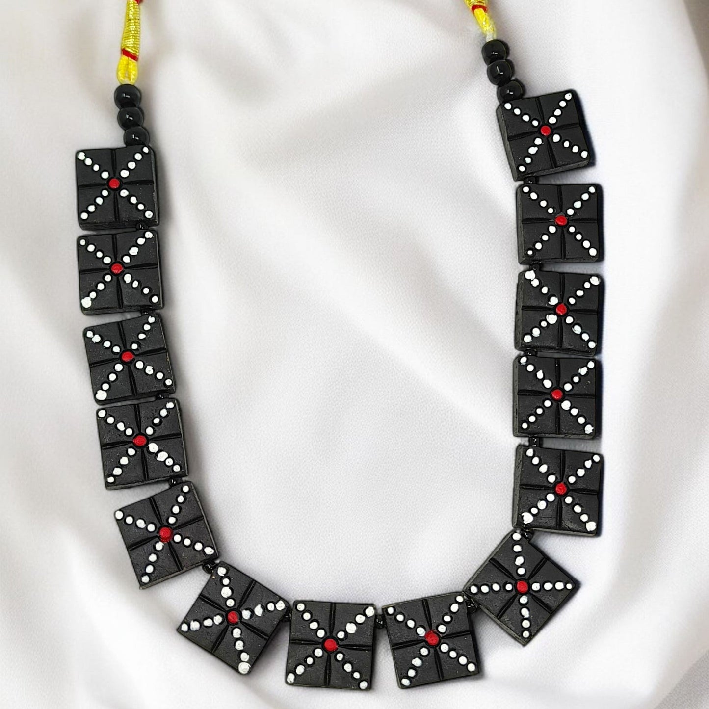 Handmade Black Beaded Necklace Set with square black beads featuring white and red dot patterns on yellow string