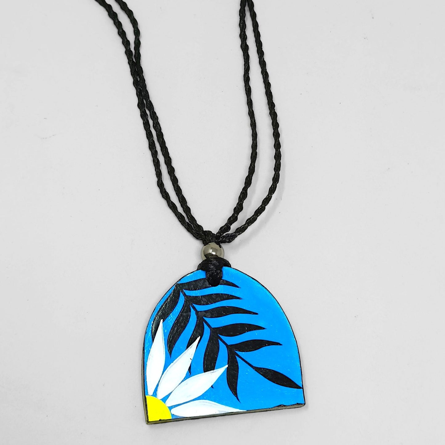 Modern Bohemian Floral Print Handmade Necklace with blue pendant featuring white flower and black leaves on black braided cord