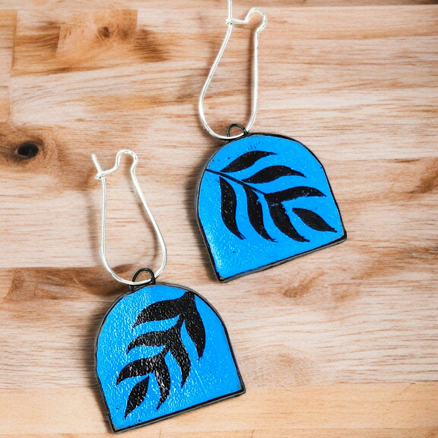 Modern Bohemian Floral Print Handmade Necklace with blue leaf design on wooden background