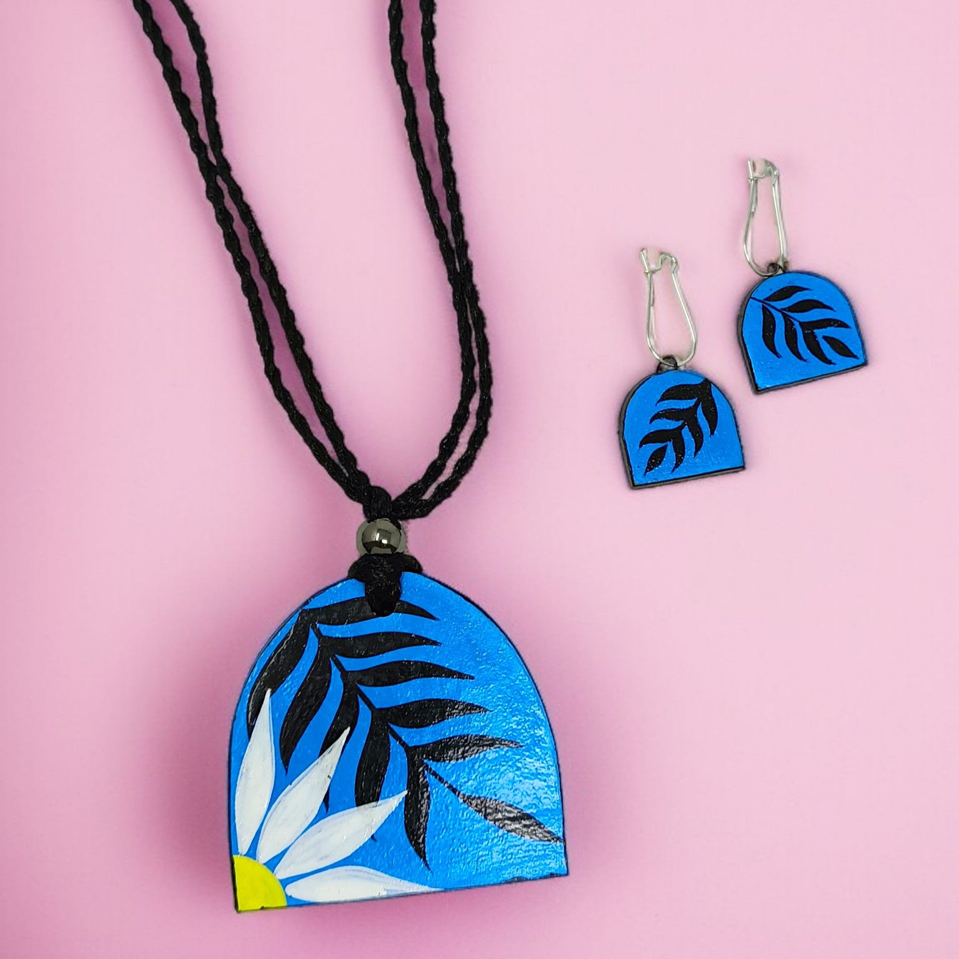 Modern Bohemian Floral Print Handmade Necklace with matching blue floral earrings on pink background