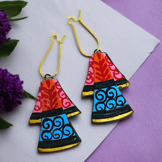 Colorful handcrafted earrings with red, pink, blue, and black patterns and gold hooks by Mrritika Handmade Jewelry