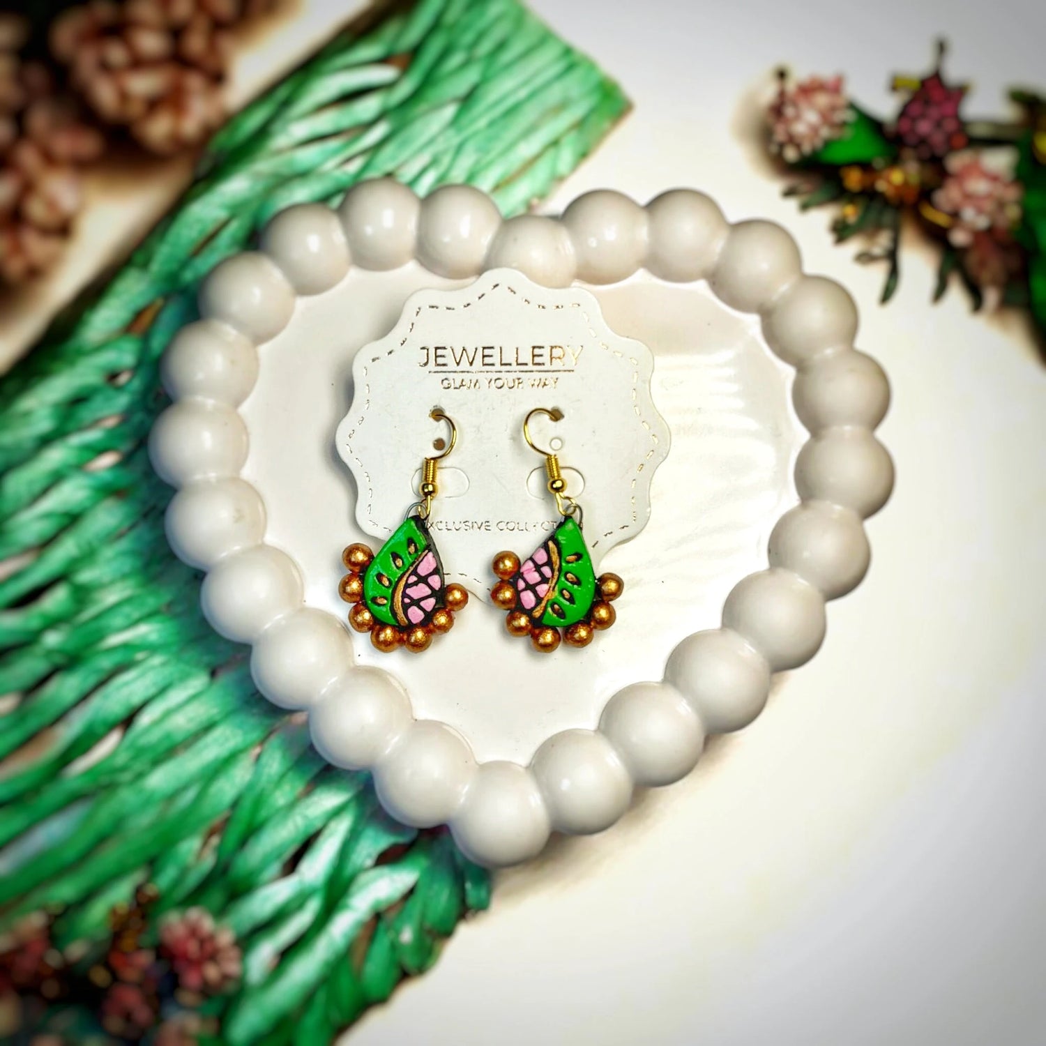 Handmade earrings for women with blue and gold bead design displayed on a white jewelry card 
