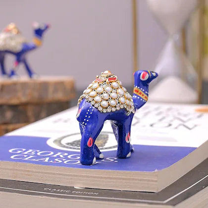 Blue camel figurine with pearl and bead embellishments handcrafted home decor India on books