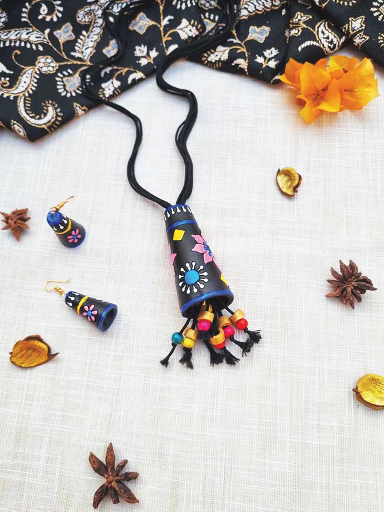 Affordable Handmade Cone Terracotta Pendant and Earring set with colorful floral designs on black background
