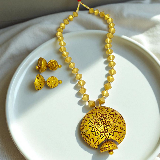 Mrritika Bishnupur Handpainted Terracotta Necklace Set with yellow beads and matching earrings on white plate