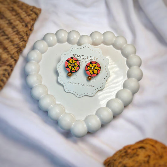 Floral Design Studs Handmade Jewelry in vibrant colors displayed on a white bead heart-shaped holder  