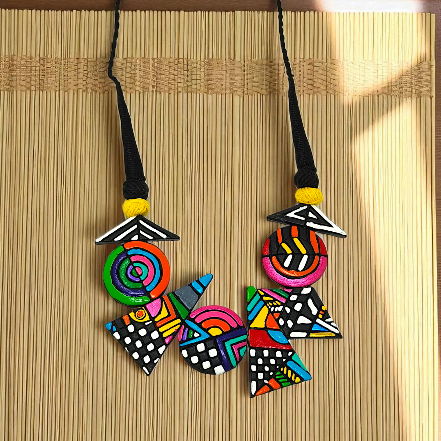 Hand made Geometrical Terracotta Necklace Set featuring colorful geometric shapes and patterns on a black cord