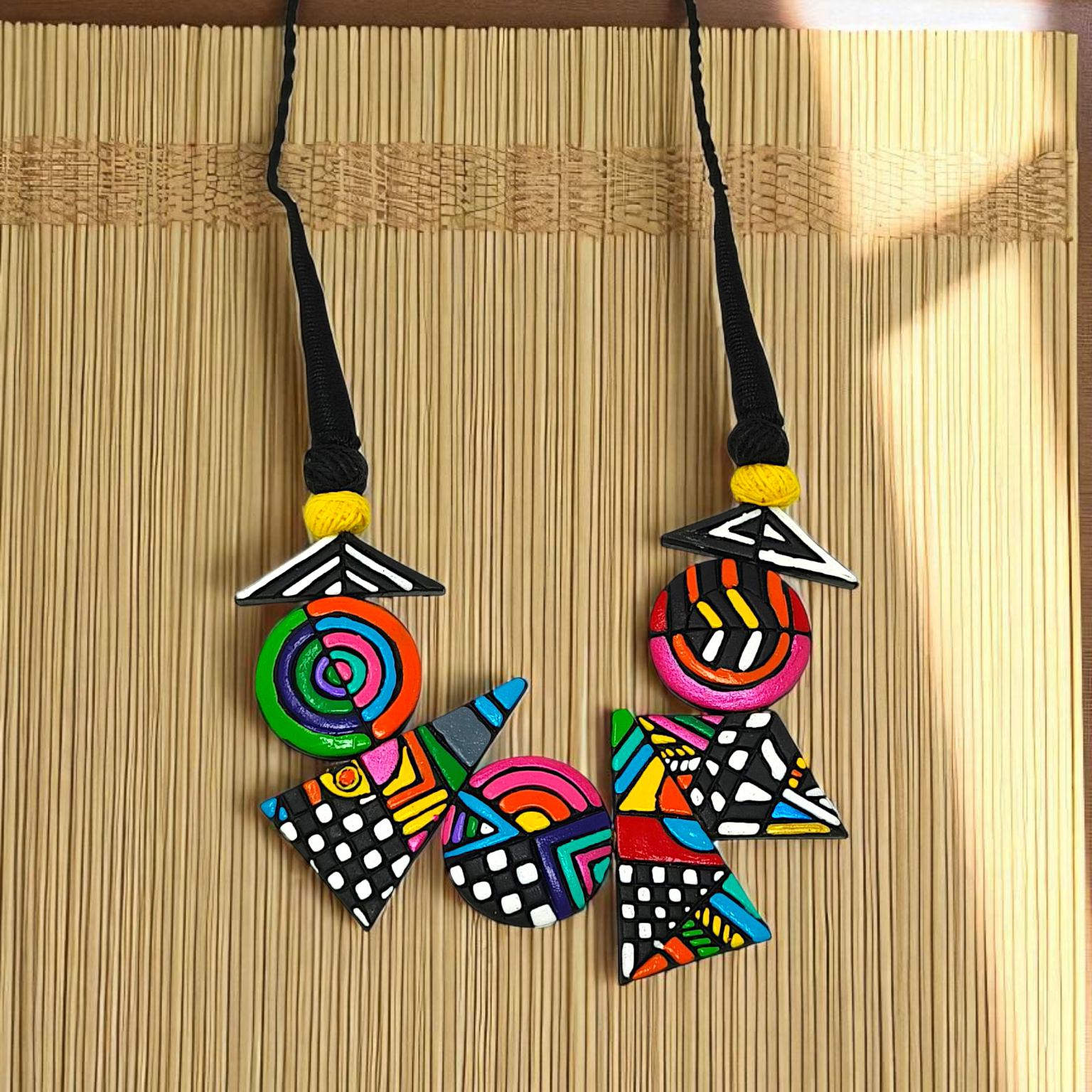 Hand made Geometrical Terracotta Necklace Set featuring colorful geometric shapes and patterns on a black cord