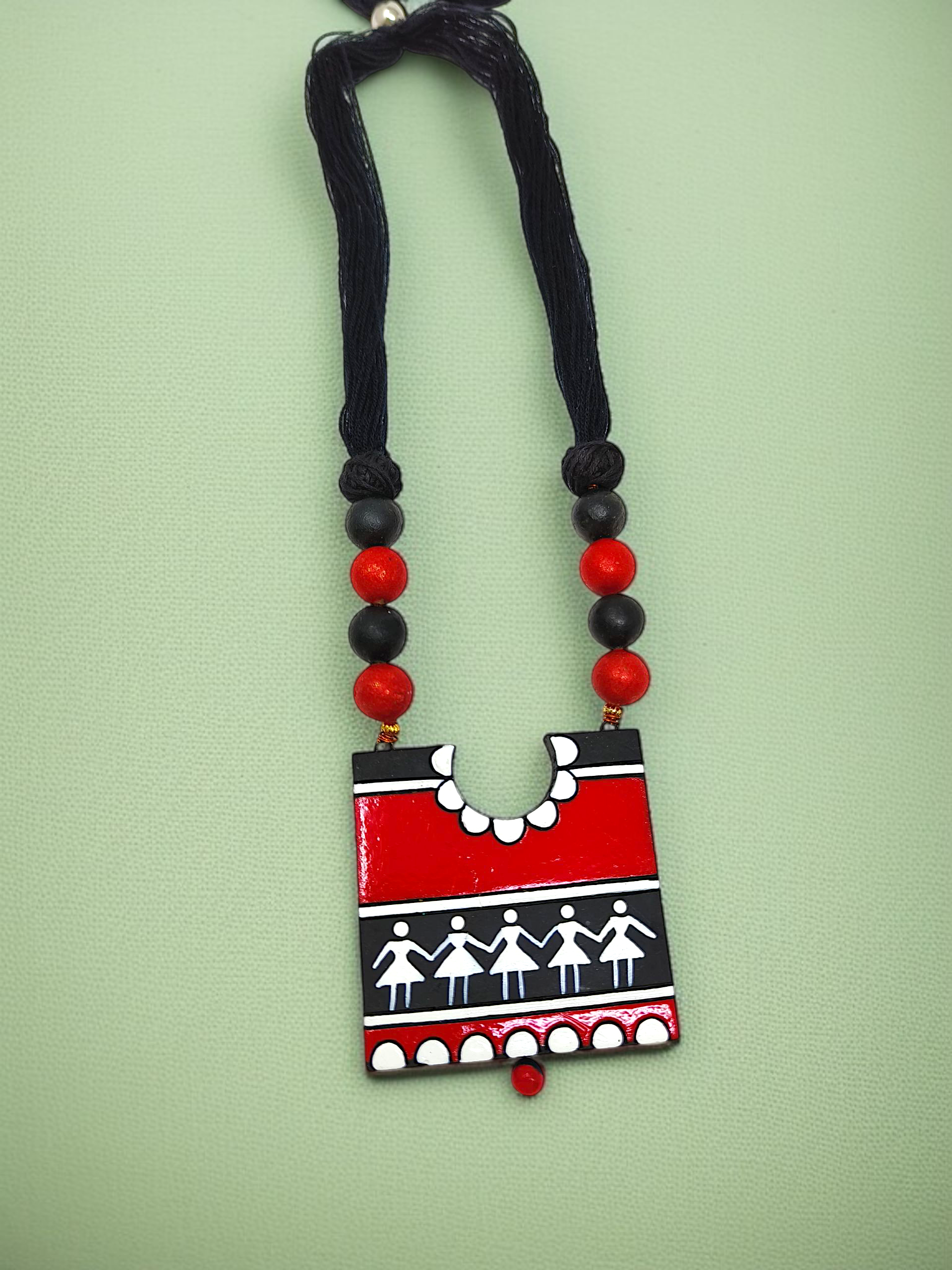 Handcrafted Warli Art Pendent and Earring featuring red and black tribal design with traditional patterns