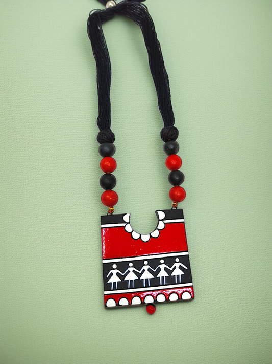 Handcrafted Warli Art Pendent and Earring featuring red and black tribal design with traditional patterns