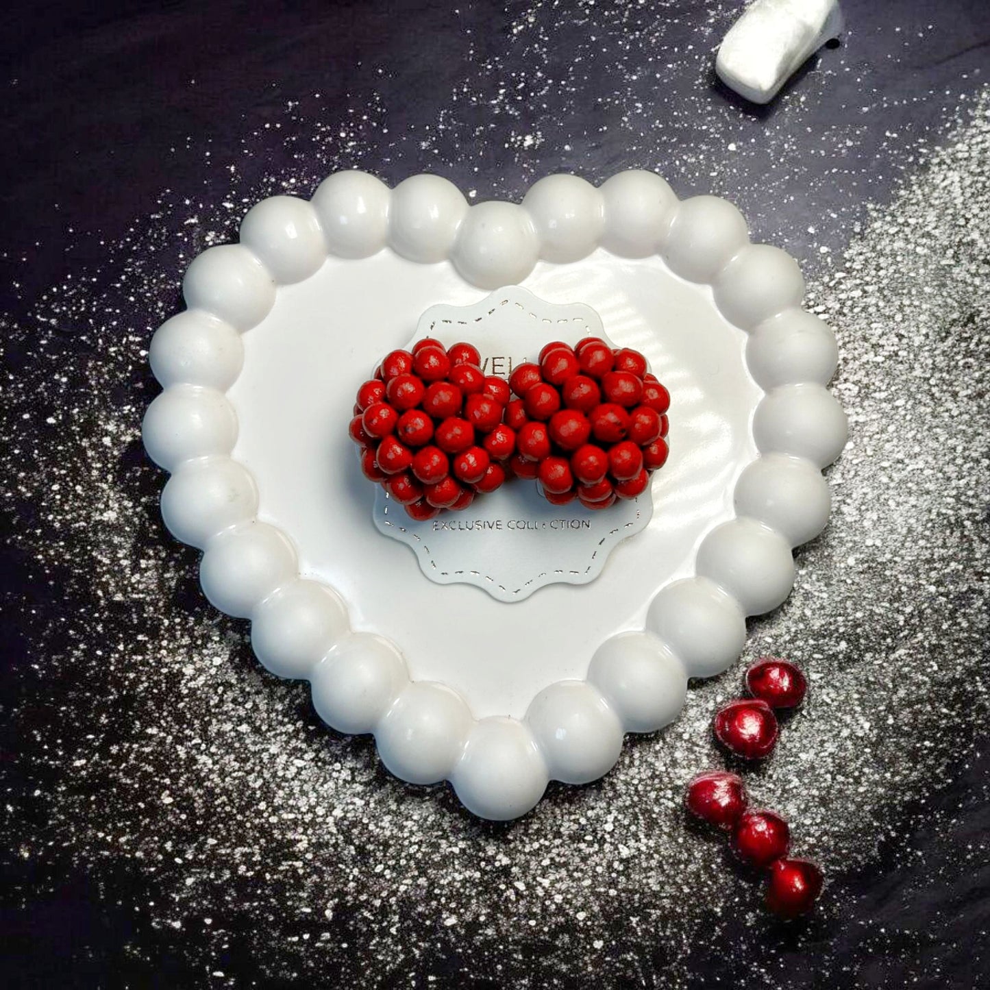 Handmade Berry Bloom Stud Earrings by Mrritika with clustered red beads on white heart-shaped background