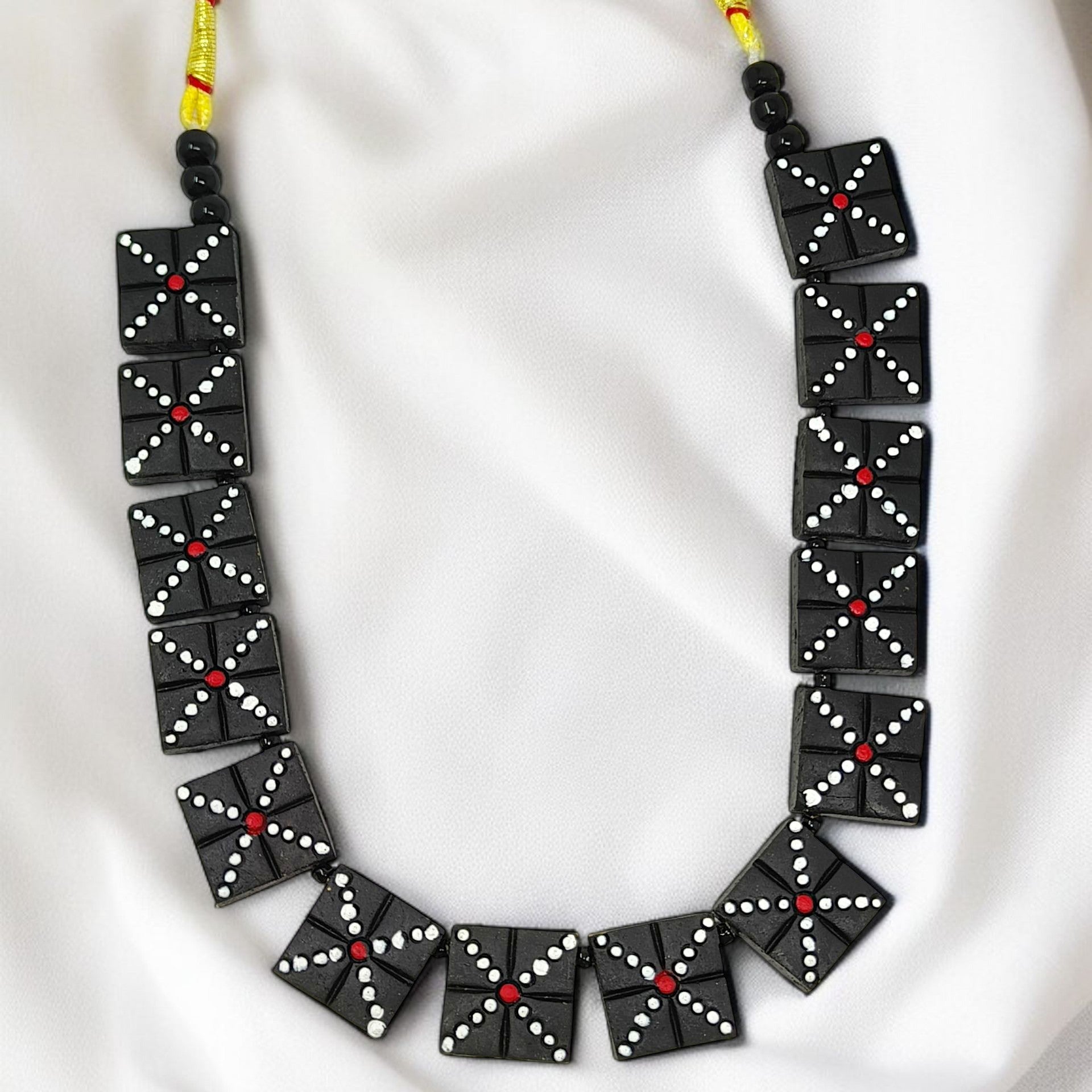 Handmade Black Beaded Necklace Set with square black beads featuring white and red dot patterns on yellow string