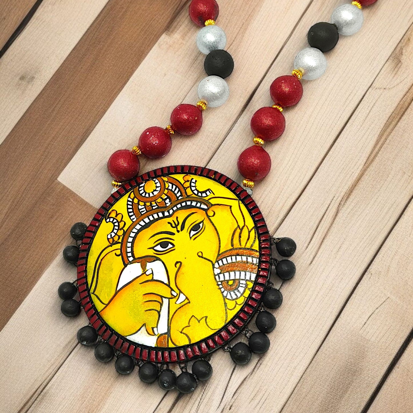 Handmade Indian necklace by ASTRIA JEWELLERY featuring a colorful Ganesha pendant with red, white, black beads