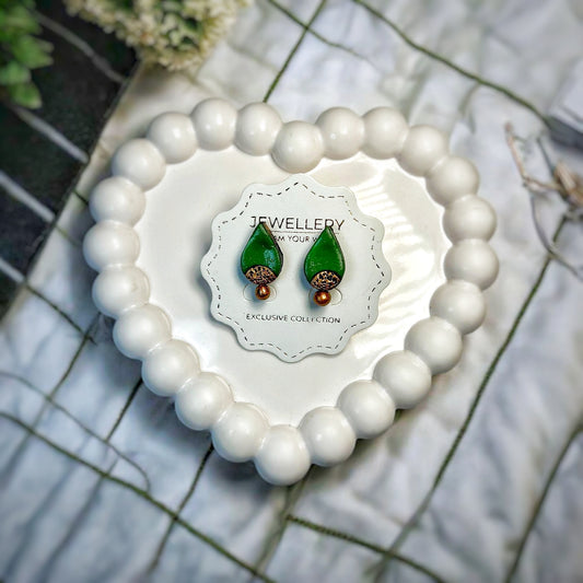 Handmade Studs Earrings Green Bridal Drops displayed on white heart-shaped bead holder