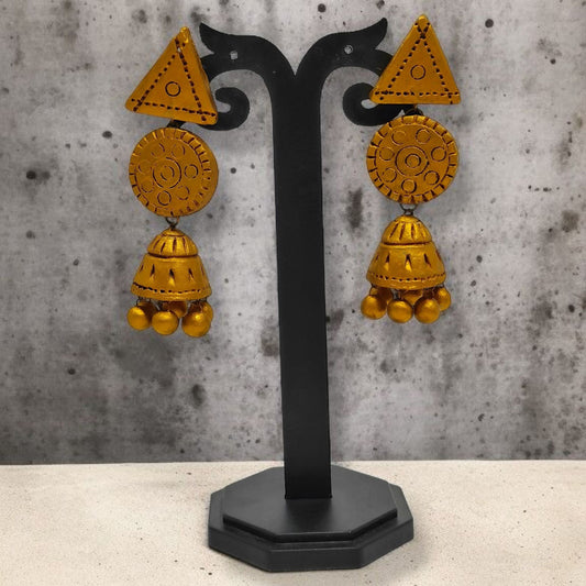 Handmade terracotta jhumka earrings with geometric and floral designs displayed on black stand