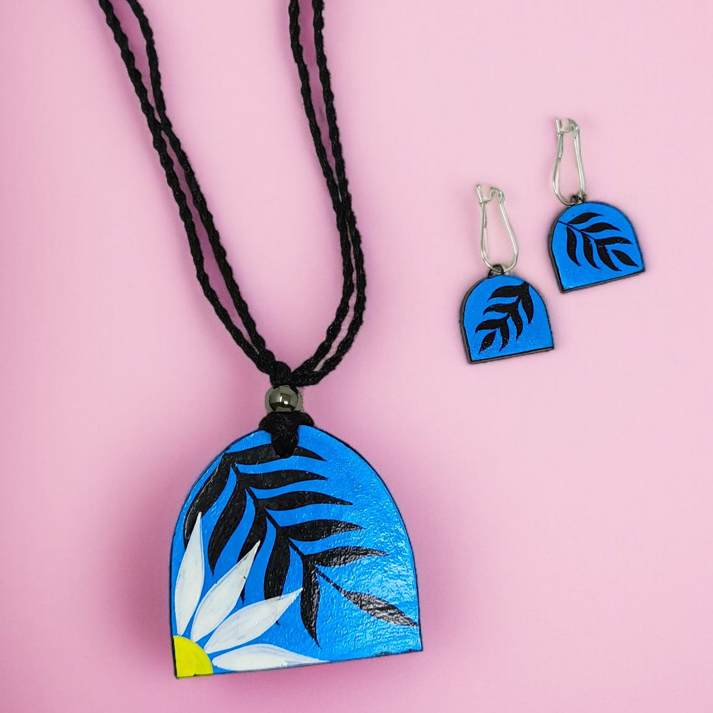 Modern Bohemian Floral Print Handmade Necklace with matching blue floral earrings on pink background