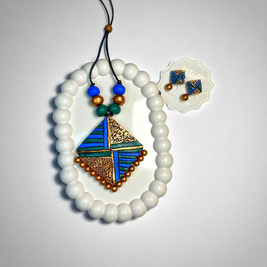 Modern tribal necklace handcrafted with white beads and blue, gold, and green geometric pendant by Mrritika