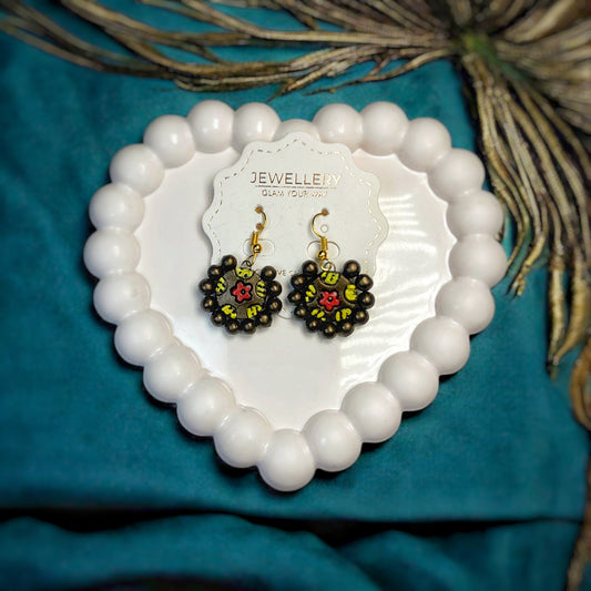 Artisanal Terracotta Earrings with Boho Touch Mrritika Handcrafted black floral design with red and yellow accents