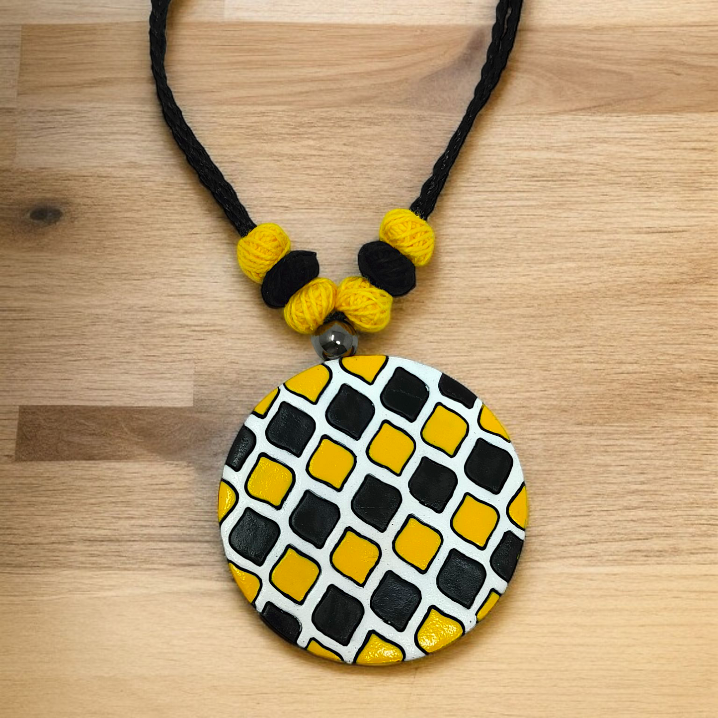 Sun Shape Minimal Handmade Terracotta Necklace with Earring featuring black and yellow beads and a round pendant with geometric patterns