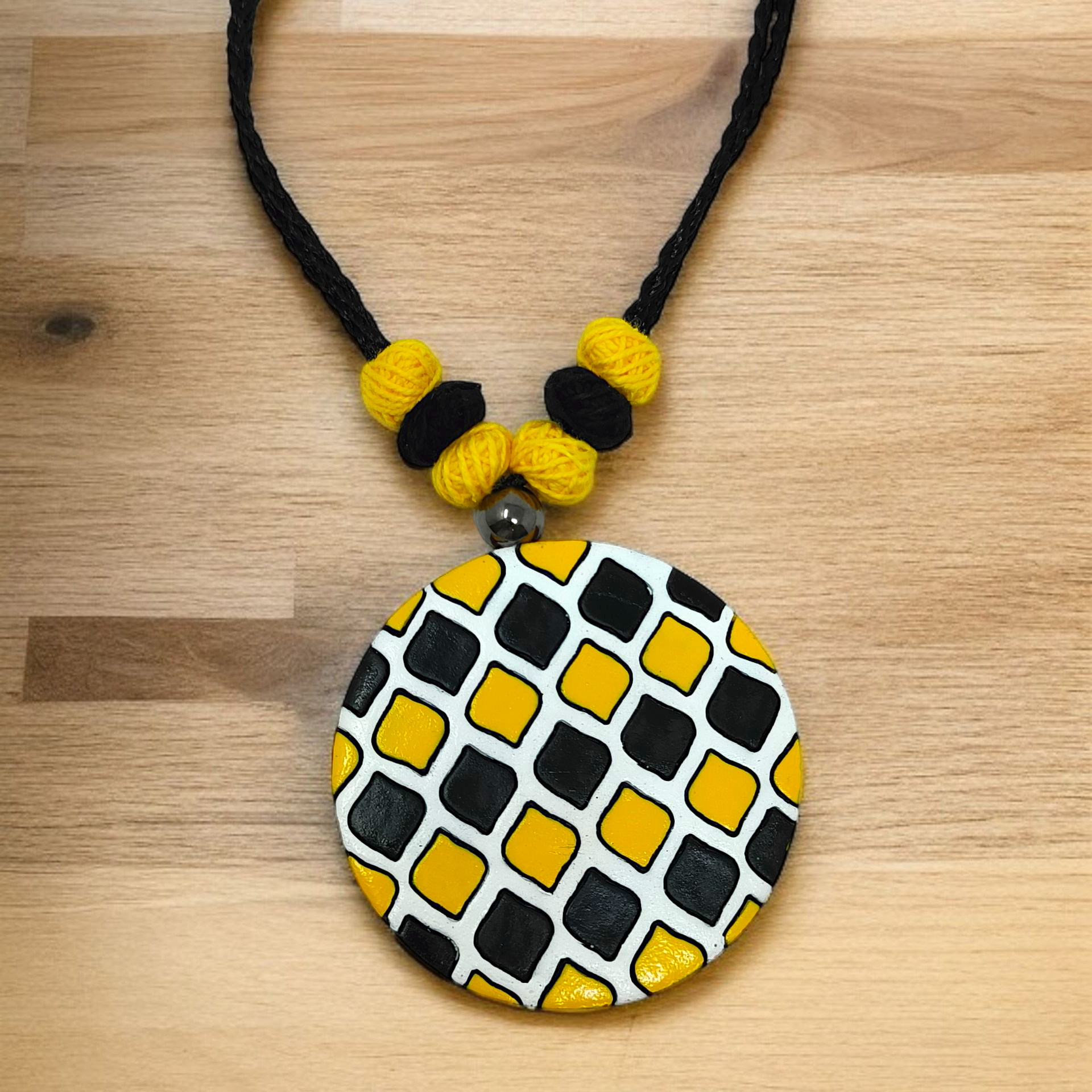 Sun Shape Minimal Handmade Terracotta Necklace with Earring featuring black and yellow beads and a round pendant with geometric patterns