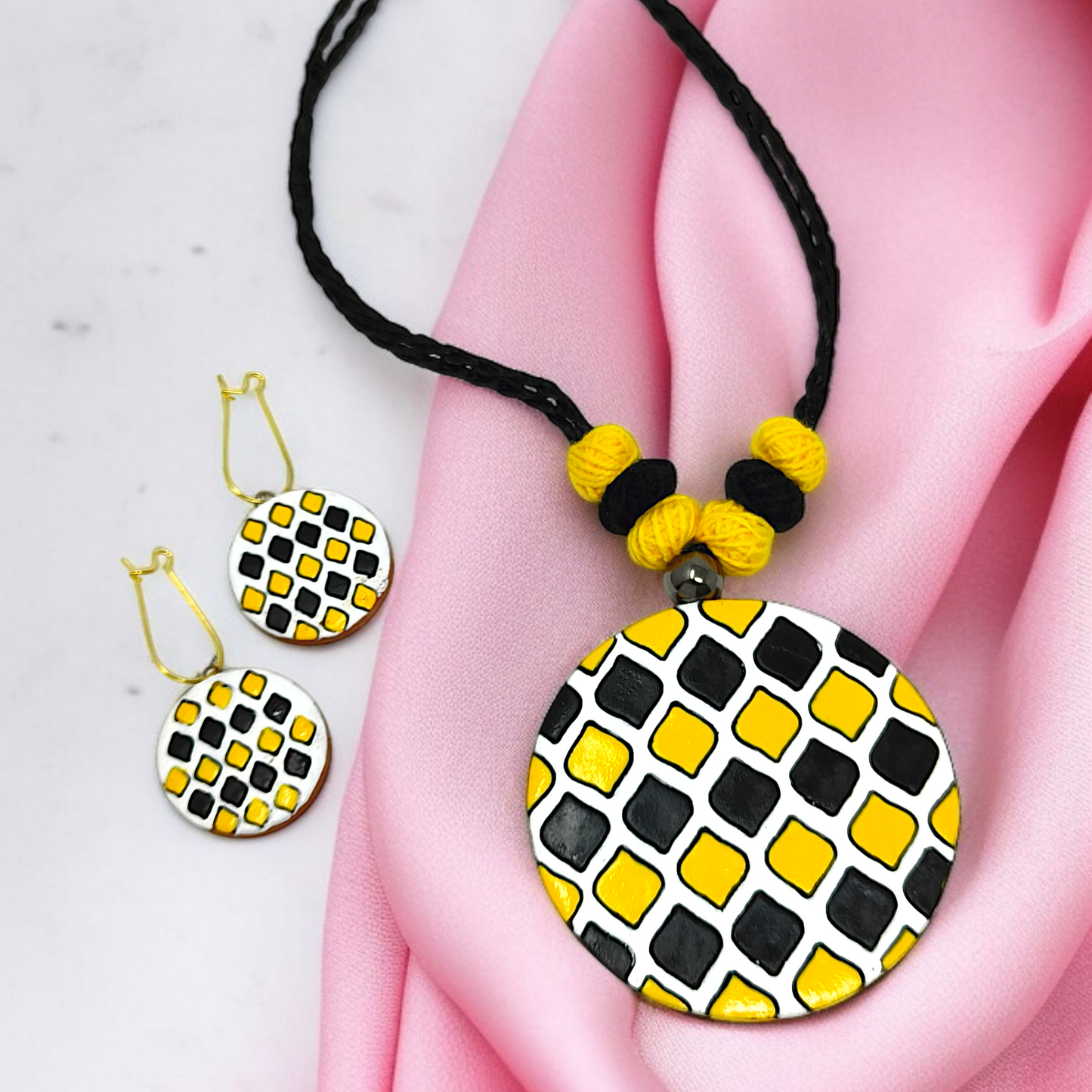 Sun Shape Minimal Handmade Terracotta Necklace with Earring featuring black and yellow geometric design on a black braided cord