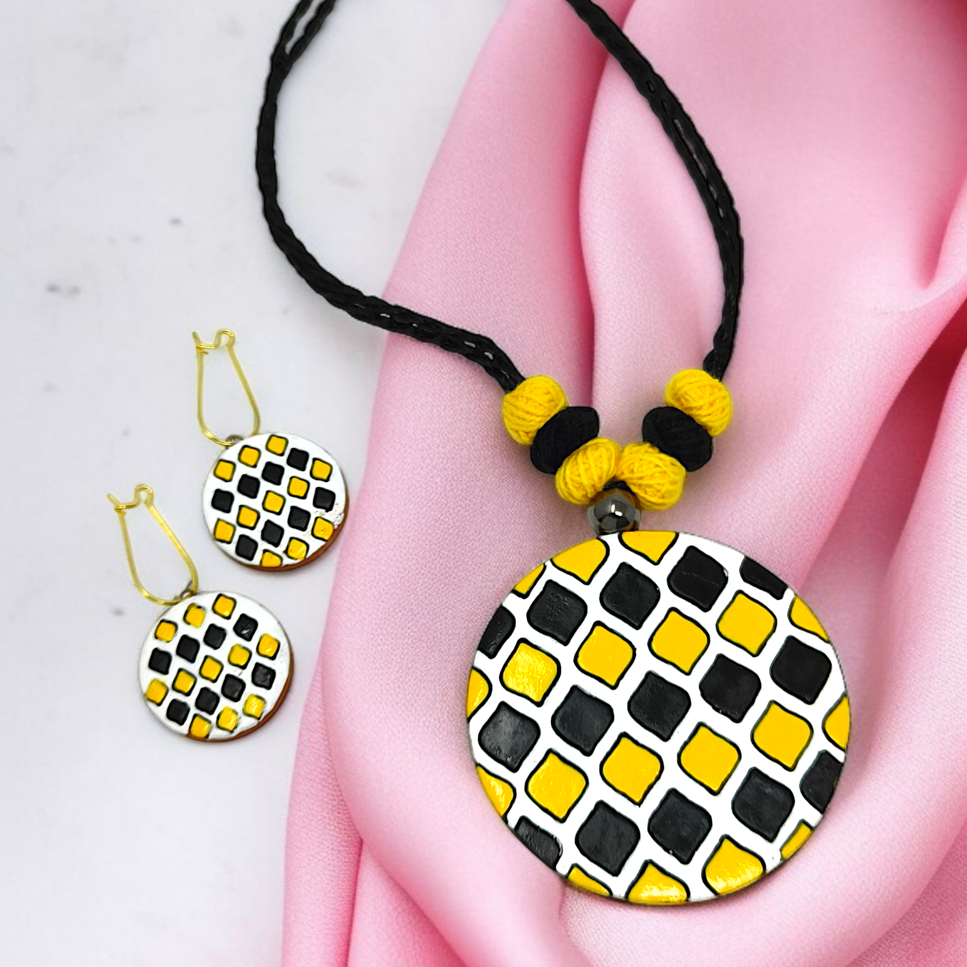 Sun Shape Minimal Handmade Terracotta Necklace with Earring featuring black and yellow geometric design on a black braided cord
