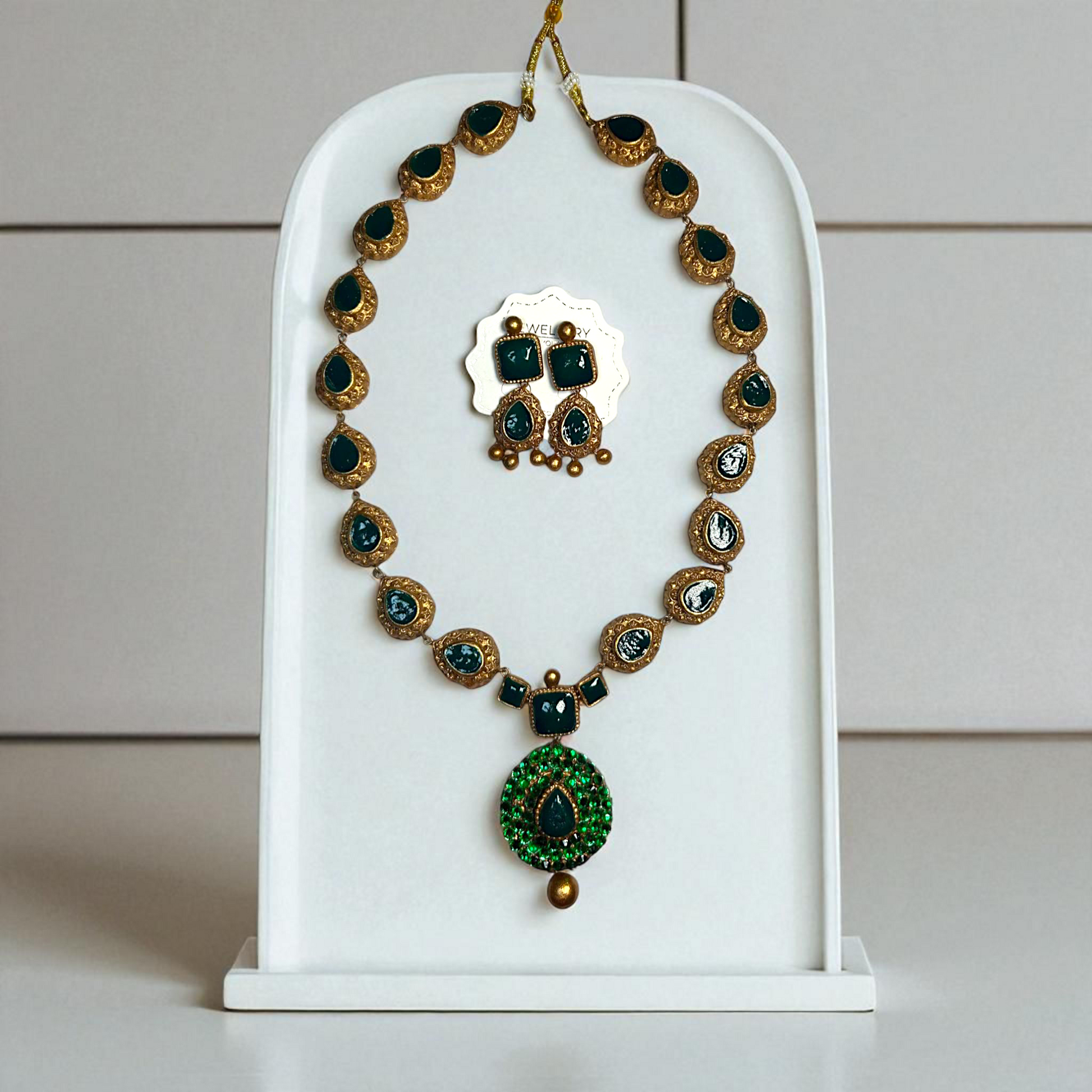Terracotta Jewelry Ethnic Green Gemstone Necklace and Earring set displayed on white stand by ASTRIA JEWELLERY