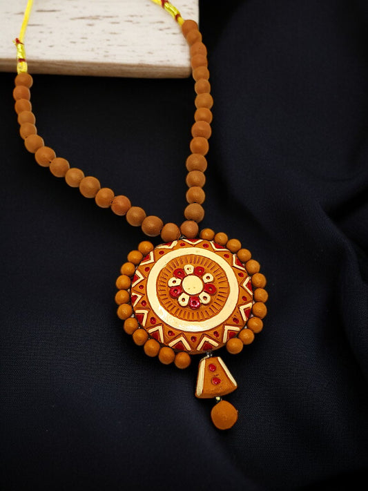 Unique Handmade Dokra Tribal Jewellery Online featuring a round pendant with intricate details and brown beaded necklace