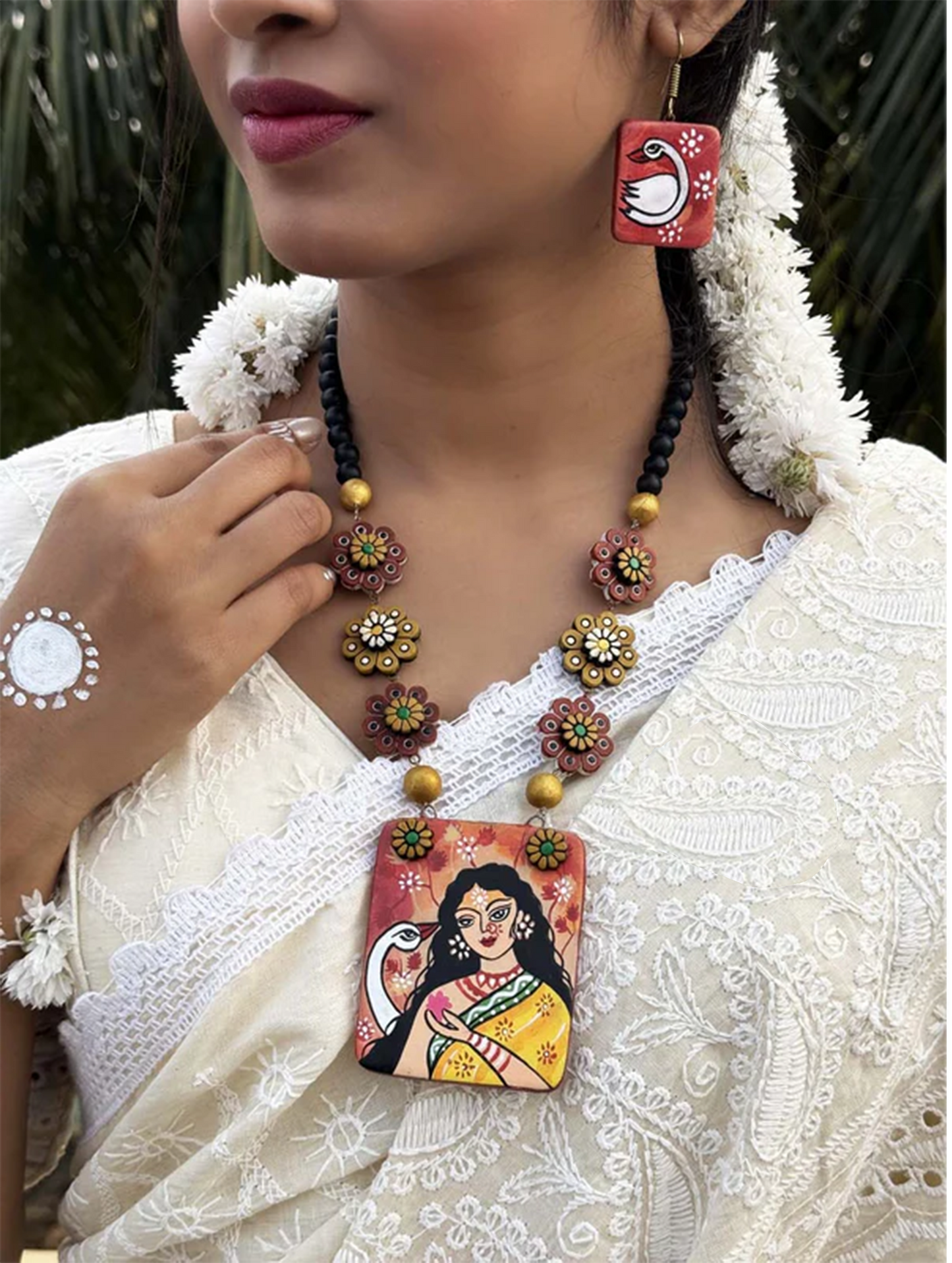 Vagdevi Hand-painted Terracotta Jewelry Set with floral beads and artistic pendant worn with traditional outfit