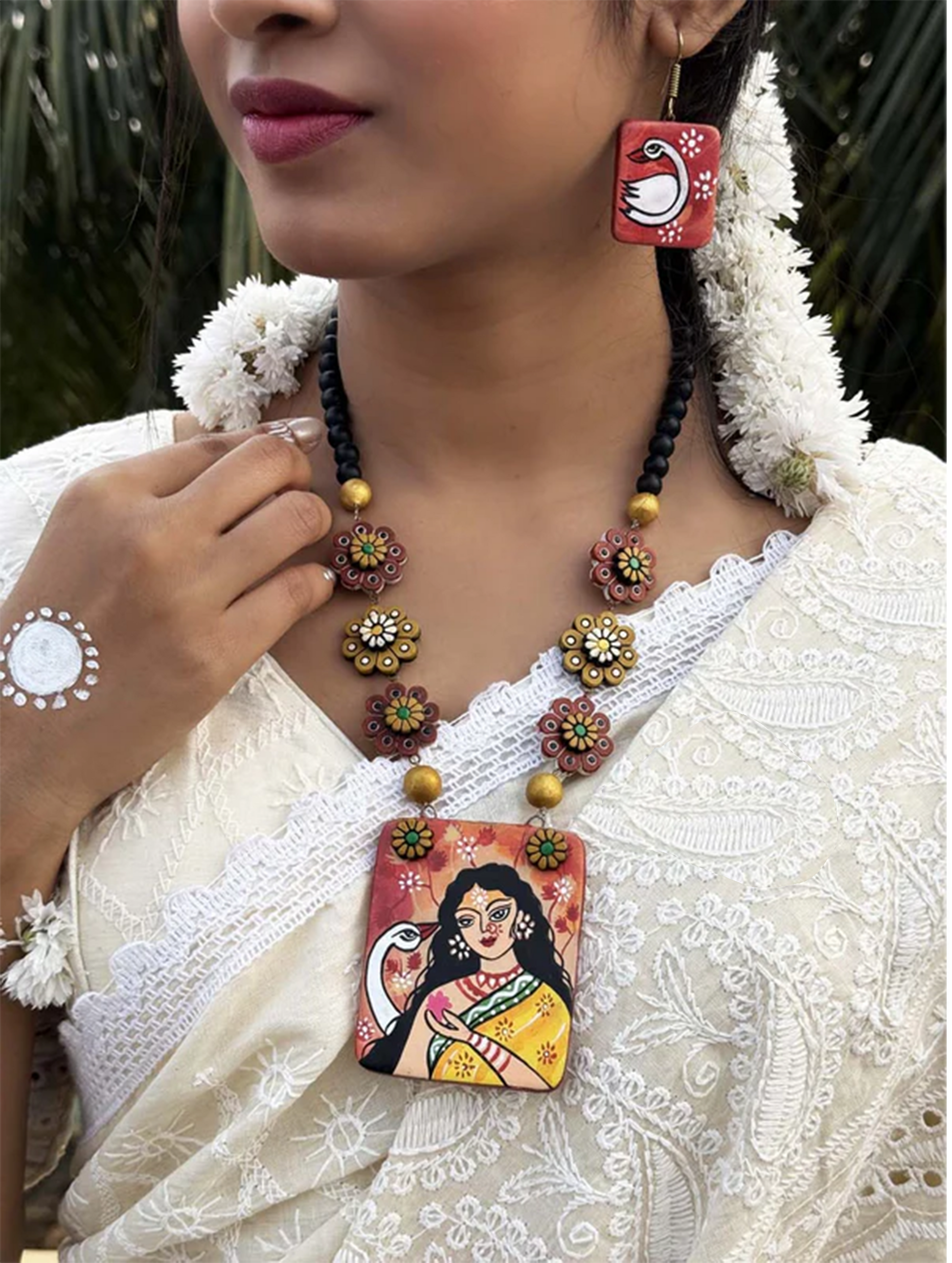 Vagdevi Hand-painted Terracotta Jewelry Set with floral beads and artistic pendant worn with traditional outfit